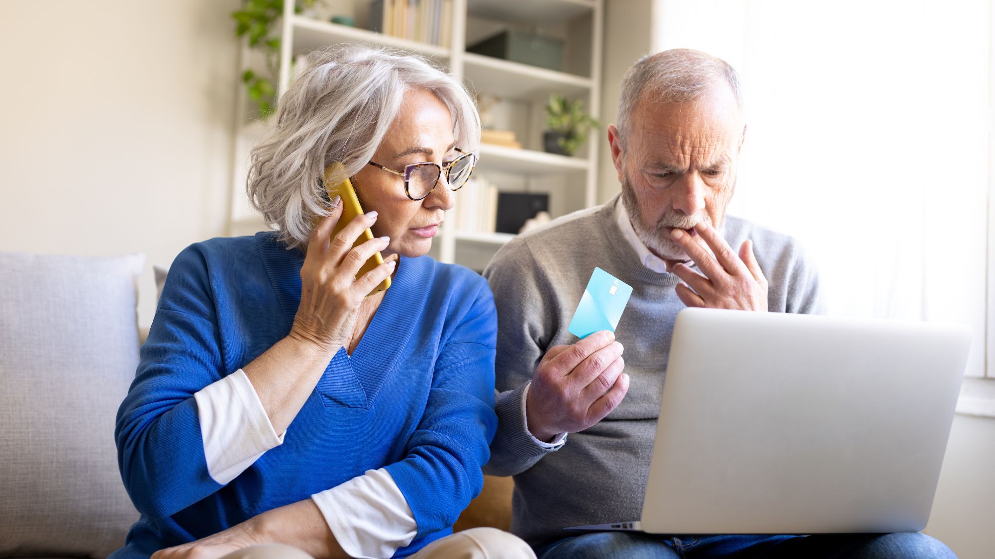 older people looking at computer, concerned