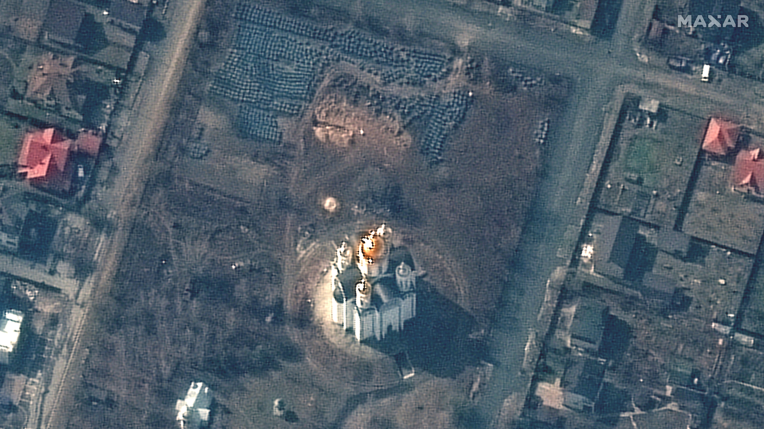 A WorldView-3 satellite image of grounds of the Church of St. Andrew and Pyervozvannoho All Saints, on March 31. A mass grave can be seen top center.