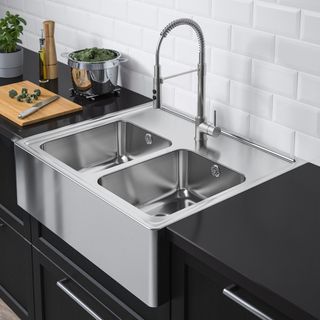 Stainless steel two bowl sink on black countertop