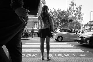 Image of a woman at the Abbey Road crossing, in black-and-white, taken on the Sigma 18-50mm f/2.8 DC DN | C Canon RF