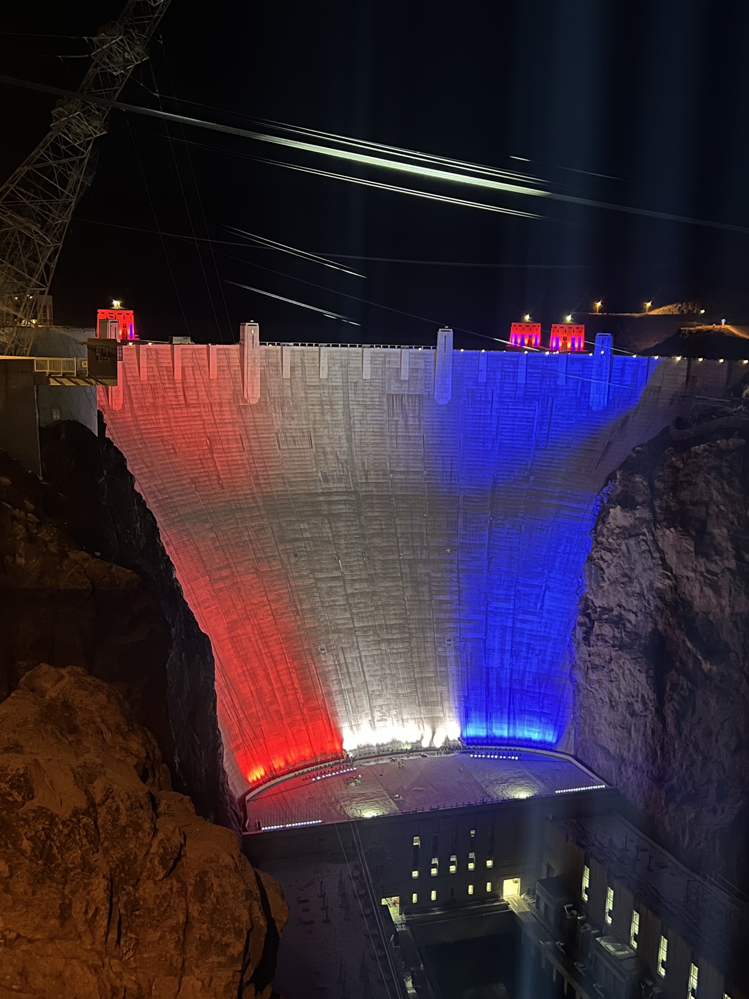 The Hoover Dam lit up in red, white, and blue with the American flag for the 250th anniversary.