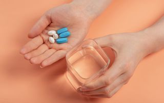 Woman's-hand-with-supplements-how-to-increase-fertility