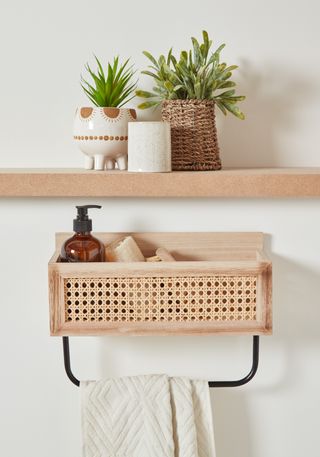 natural materials cane and wood wall hung bathroom caddy with towel rail