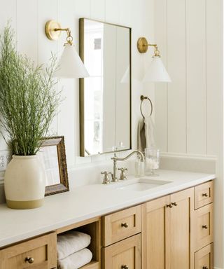 Neutral bathroom with warm white walls and wood cabinets