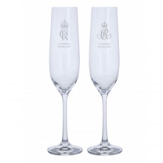 Two Darlington champagne flutes with coronation engravings on white background