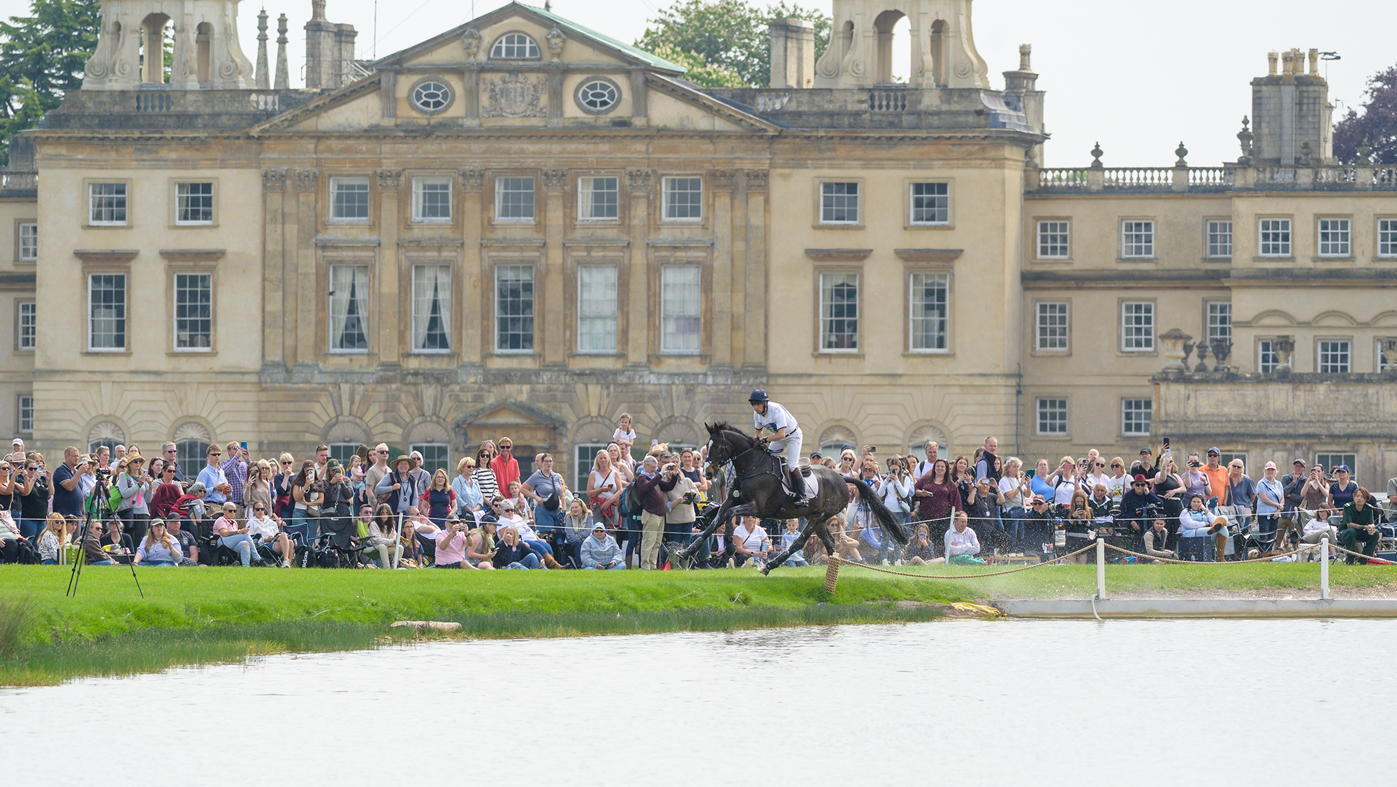 Harry Meade and Annaghmore Valoner gallop in front of Badminton House at the 2026 horse trials.