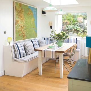 Breakfast nook with banquette seating and striped upholstery with wood-effect vinyl flooring