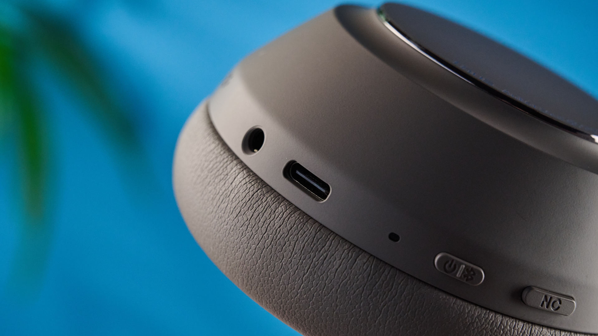 the anker soundcore space 2 pro headphones in mauve gray photographed against a blue tom's guide background