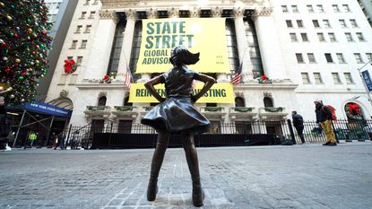 Fearless Girl statue facing State Street Global sign