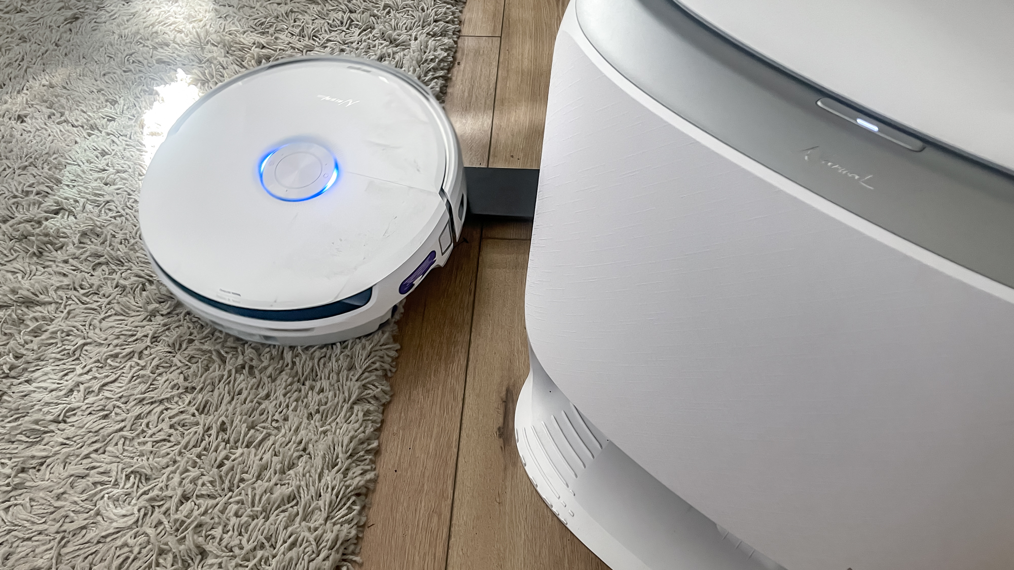 Narwal Freo 20 robot vacuum on a kitchen floor