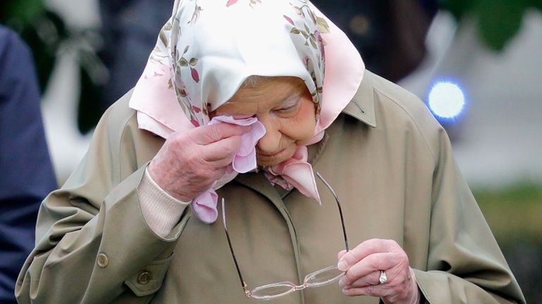 The Queen, Elizabeth II wipes her eyes with handkerchief