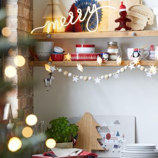 Christmas kitchen shelves with 'merry' light