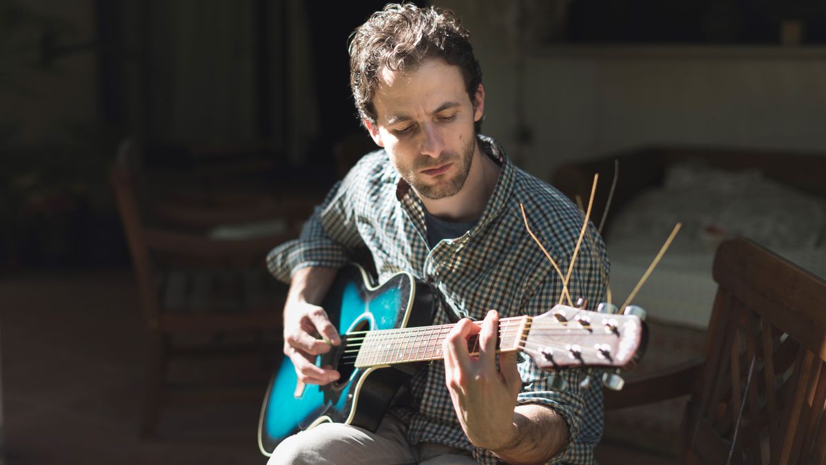 Man playing guitar chord