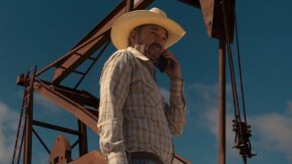 Billy Bob Thornton as Tommy on the phone with an oil drill behind him.