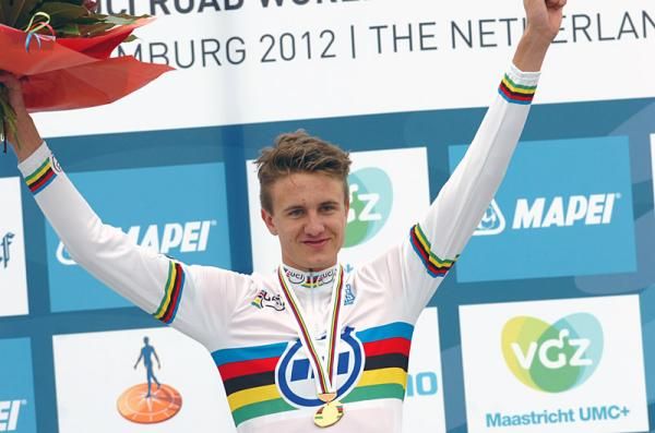 Oskar Svendsen (Norway) celebrates his junior men's time trial world championship on the podium.