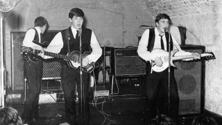 Rock and roll band "The Beatles" perform onstage at the Cavern Club on August 22, 1962.(L-R) George Harrison, Paul McCartney, John Lennon.