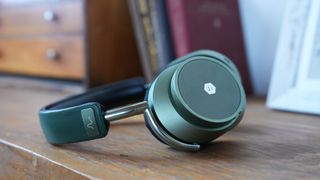 Neurable MW75 LT in green on a wooden shelf