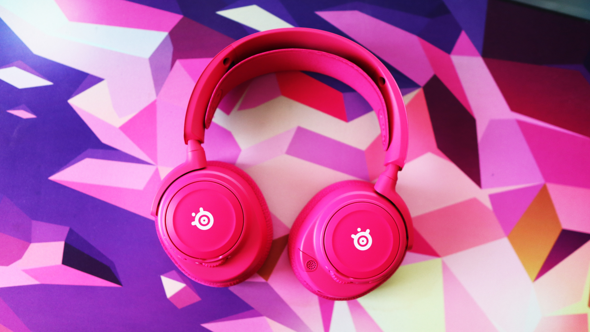 SteelSeries Arctis Nova 7X Wireless Gen 2 in pink on a mouse pad.
