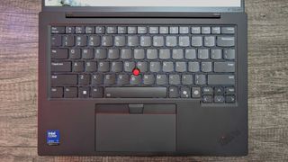 The Lenovo ThinkPad X1 Carbon (Gen 13) Aura Edition's keyboard as seen from above, showing the touchpad and TrackPoint.