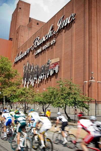 Riders pass the Anheuser-Busch headquarters near downtown.