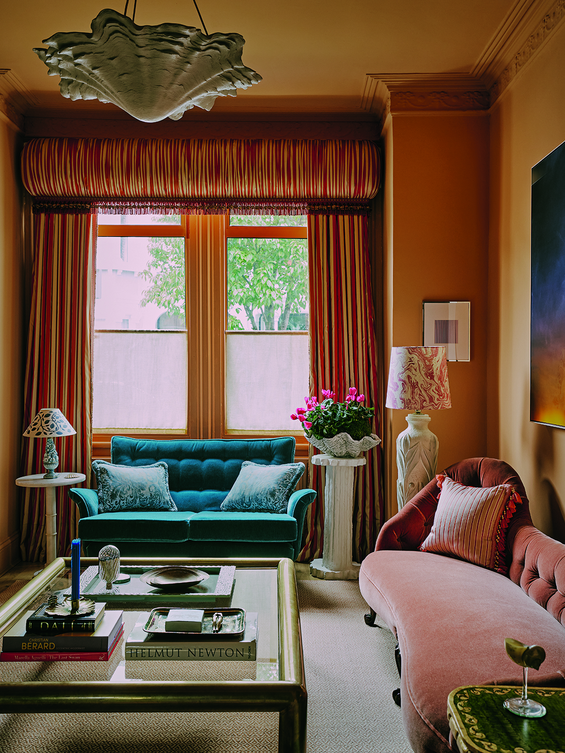 yellow living room with blue sofa looking at a window with a large pelmet