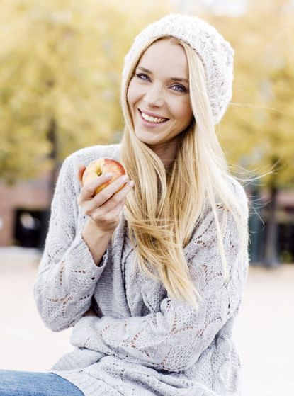 Healthy woman eating an apple