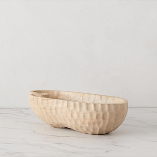 pale wood bowl with dimpled exterior and curvy design