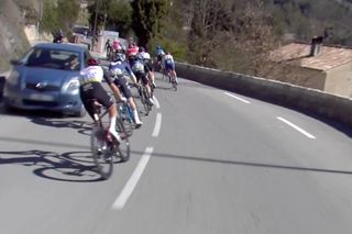 Eurosport broadcast catches the instant a chase group misses a car that found its way onto the course of Paris-Nice on stage 8