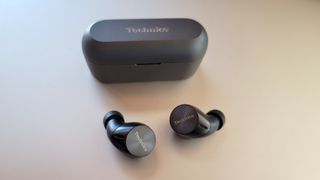 The Technics EAH-AZ60 wireless earbuds and charging case placed on a desk