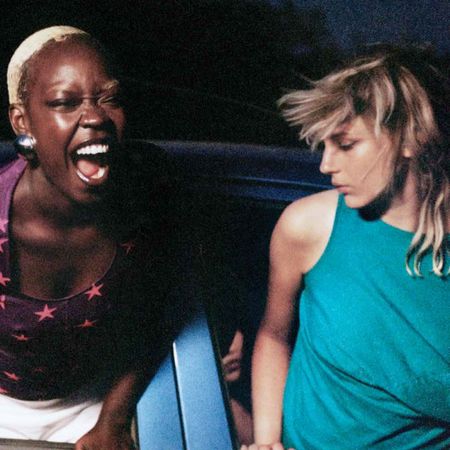 An image of two women hanging out of a car wearing gina corrieri.
