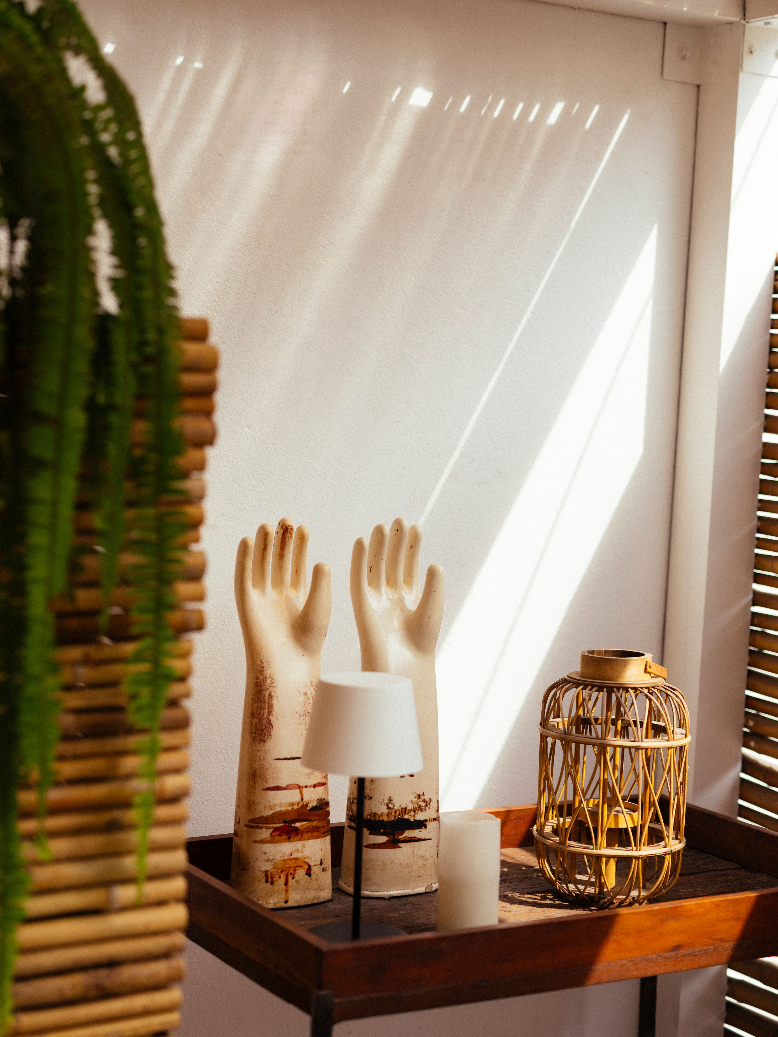 A series of images capturing the leafy interiors and exterior and the minimalist-chic rooms of a Peruvian hotel bathing in natural light.