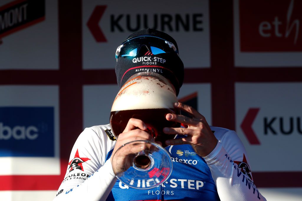 KUURNE BELGIUM FEBRUARY 27 Fabio Jakobsen of Netherlands and Team QuickStep Alpha Vinyl celebrates at podium with a beer as race winner during the 74th Kuurne Bruxelles Kuurne 2022 a 1951km race from Kuurne to Kuurne KuurneBxlKuurne on February 27 2022 in Kuurne Belgium Photo by Bas CzerwinskiGetty Images