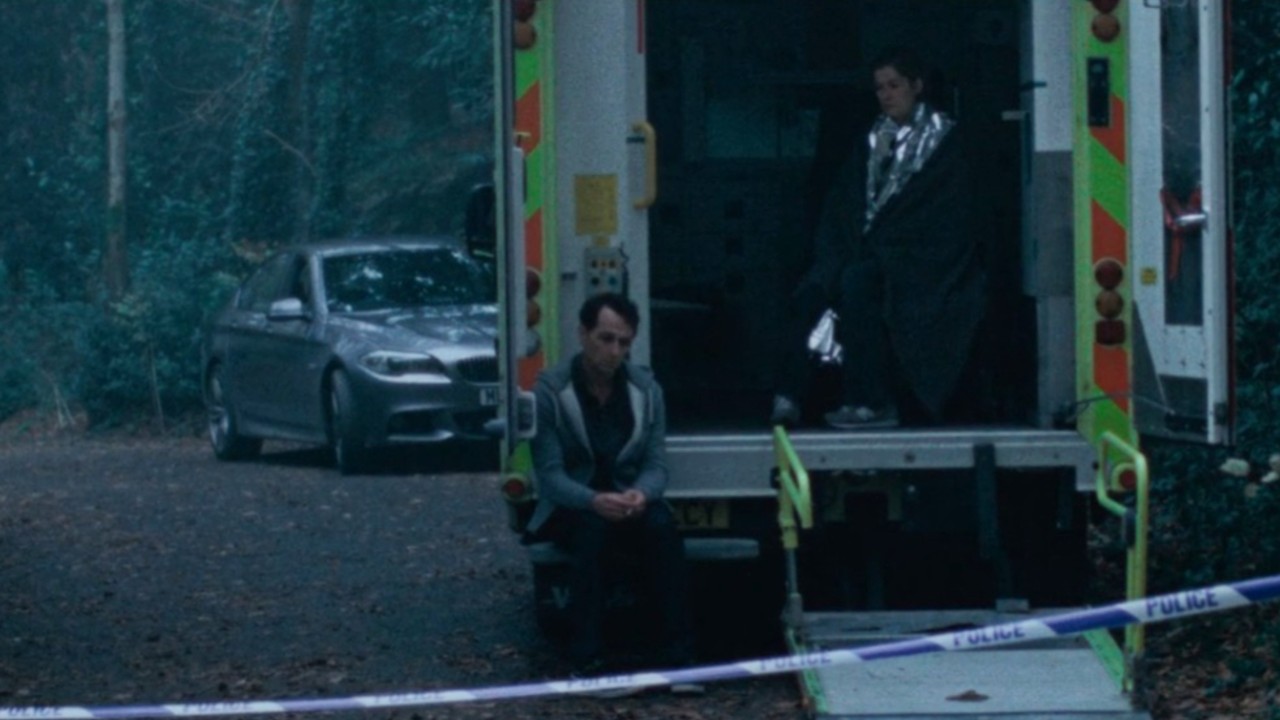 Rosamund Pike and Matthew Rhys looking devastated in an ambulance in Hallow Road.