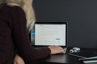 woman working on WordPress website CMS on laptop