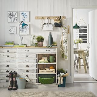 room with white wall white door and drawers with white frames