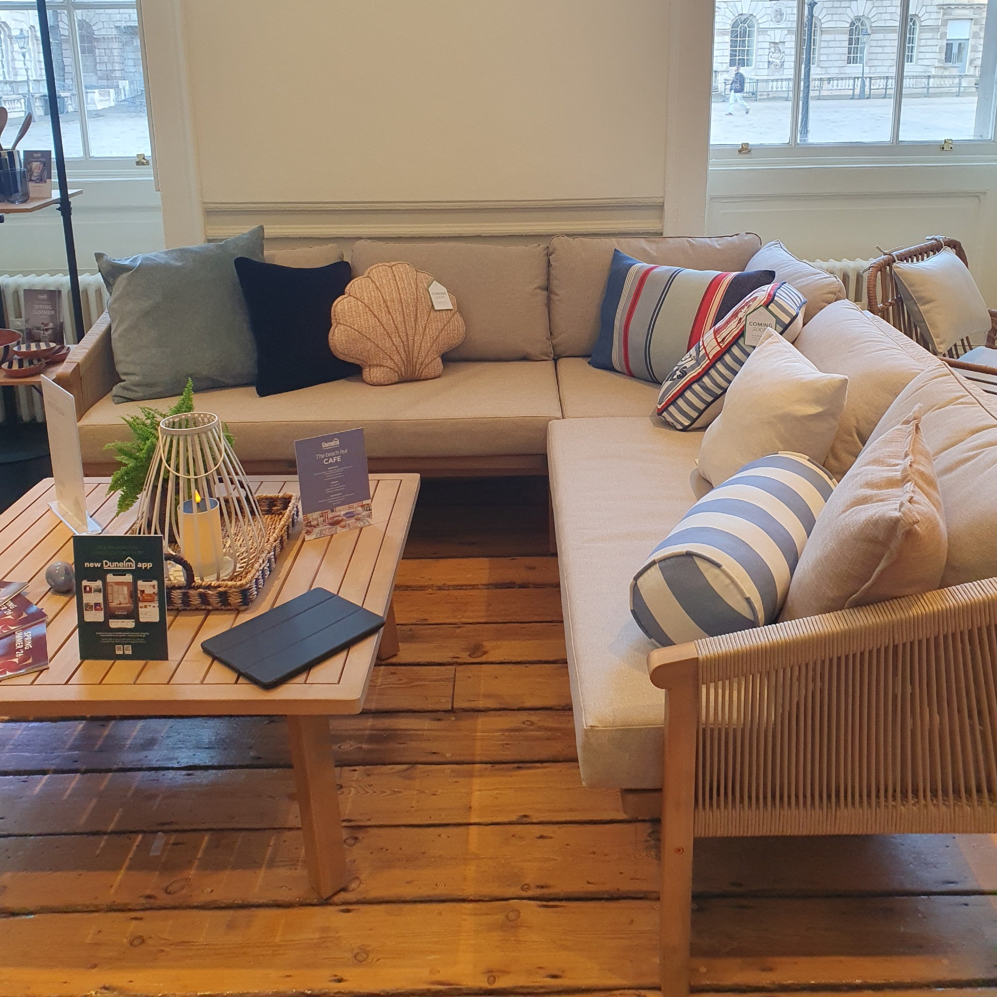A corner outdoor sofa with coastal-themed outdoor cushions at the Dunelm spring/summer 2026 press preview