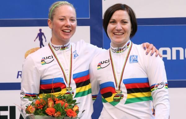 Kaarle McCulloch and Anna Meares sing Advance Australia Fair as the Australian flag is raised