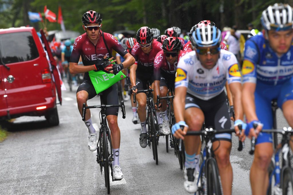 Luke Rowe grabs lunch as some rain falls on the peloton
