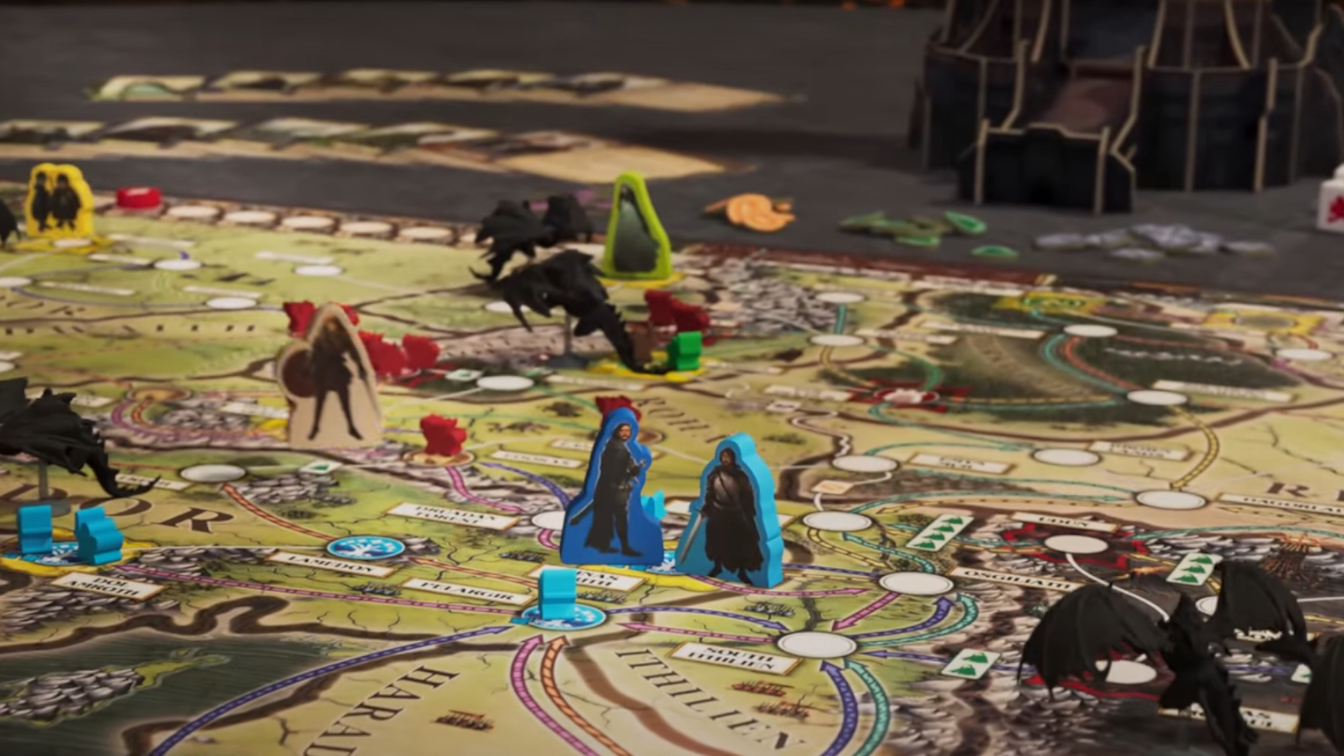 A selection of tokens, miniatures, and cards on the Fate of the Fellowship board