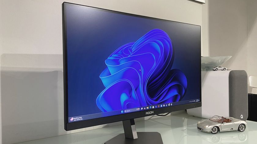 AOC Agon Pro AG276FK gaming monitor tilted slightly to the side, showing the Windows desktop screen