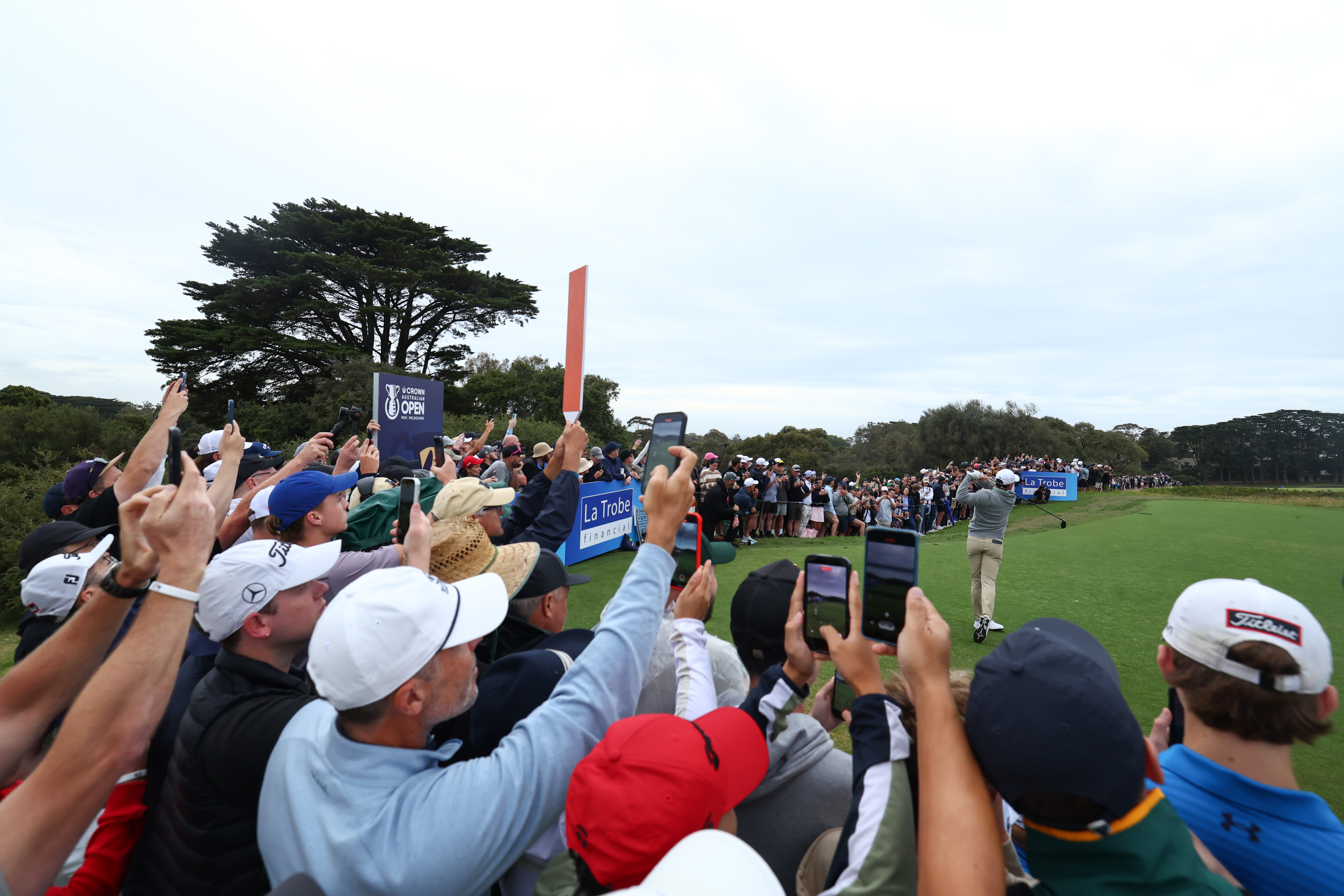 Fans take pictures of Rory McIlroy during his round