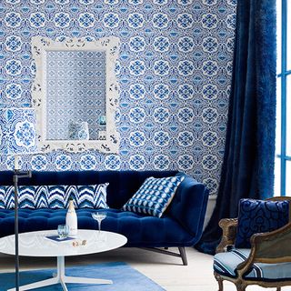 living room with blue tile wallpaper and sofa