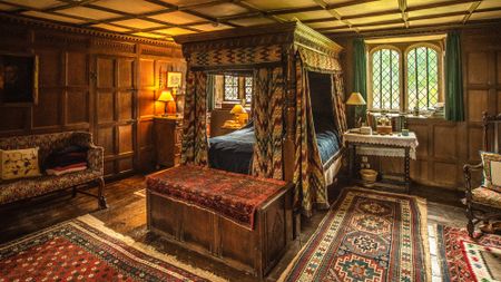 Interior of stately home showing a four-poster bed in Bowood House
