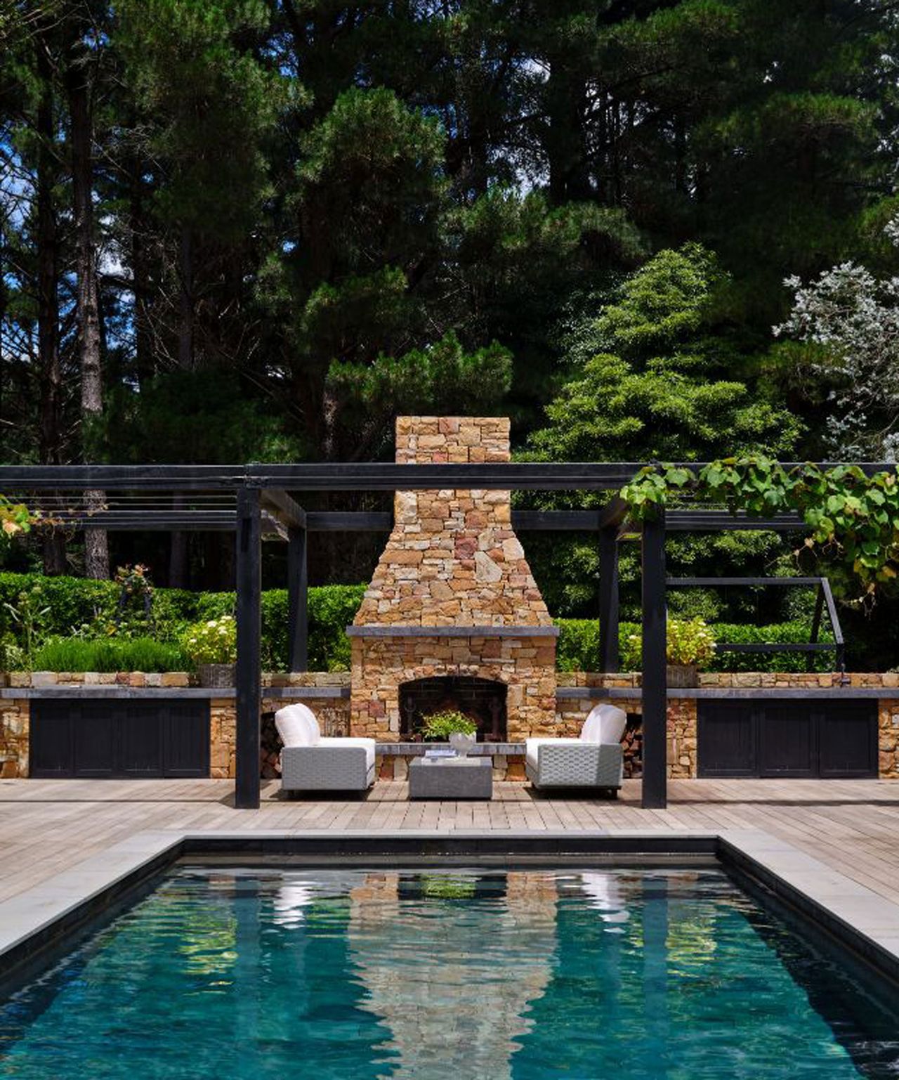 pool, outdoor fireplace and garden furniture set-up
