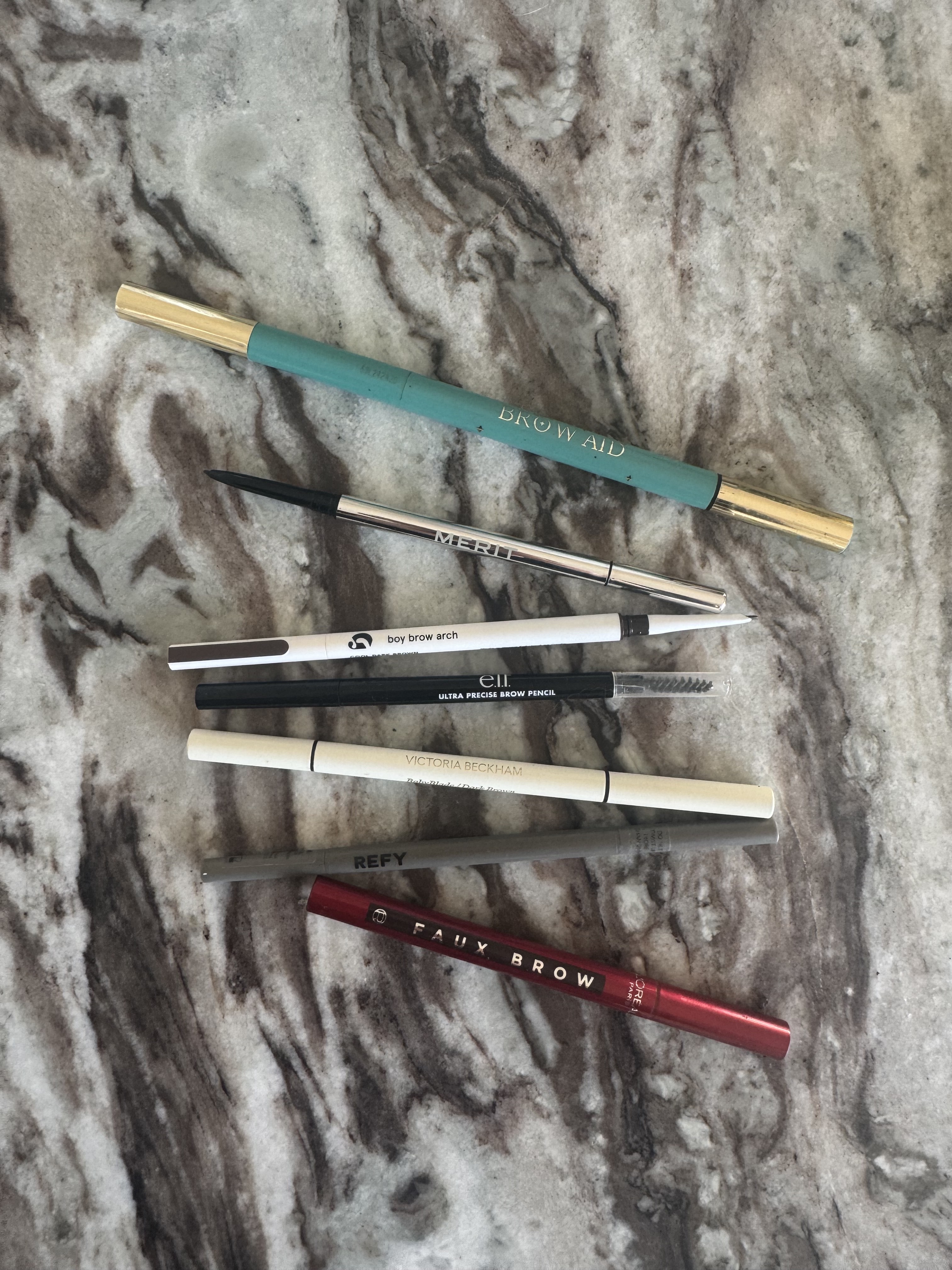 Brown pencils on a marble table