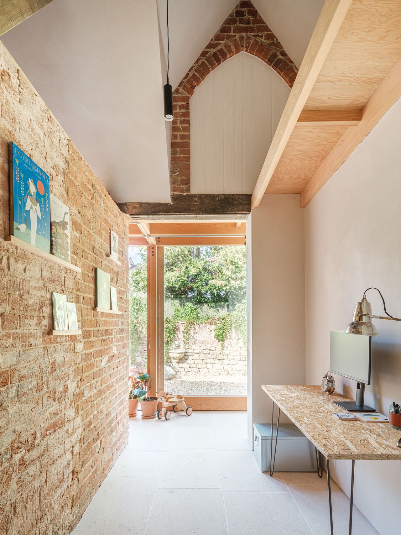 stone hallway with view to garden and seating