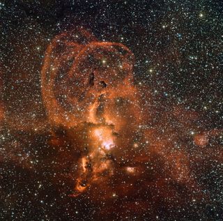 Nebula NGC 3582 contains giant loops of gas that resemble solar prominences. Researchers think dying stars ejected the loops, but this stellar nursery also produces new stars. The young stars emit ultraviolet radiation that causes the gas in the nebula to