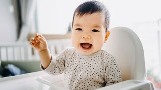 Smiling baby waving