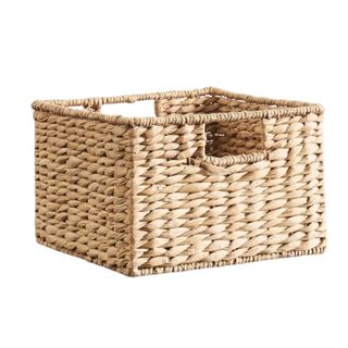 A light brown square woven storage basket with handles either side