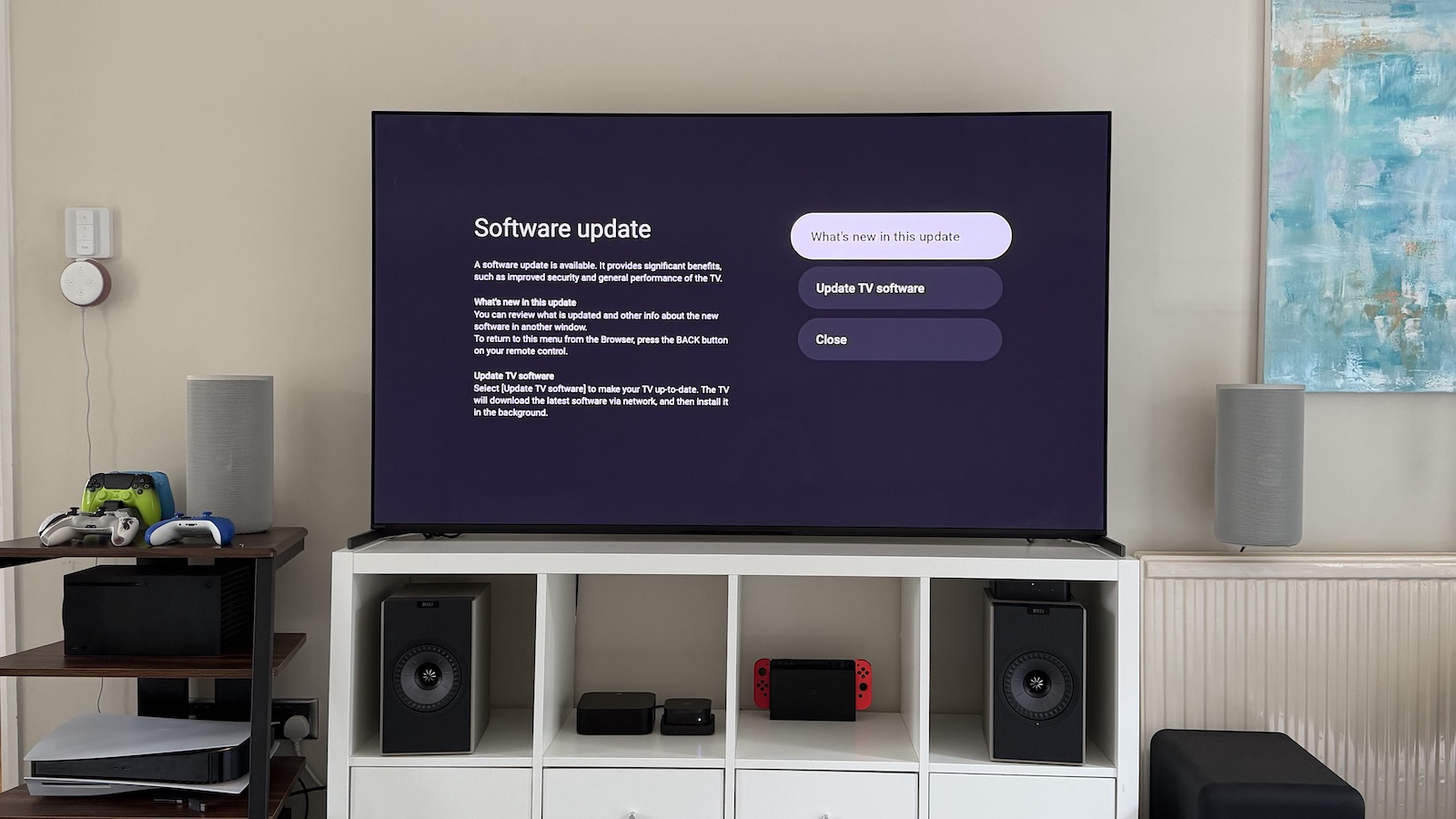 A photo of the Sony Bravia 8 II TV standing on a white bookcase in a living room